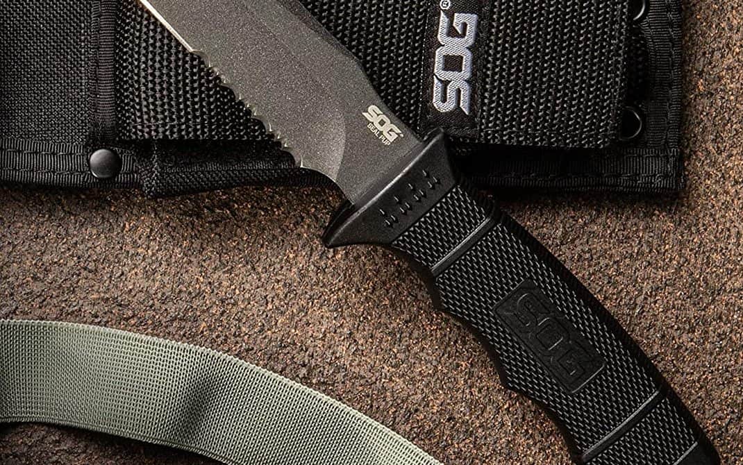 The BEST Knife Handle Materials: A Complete Guide 5 SOG Seal Pup displayed on a counter. It has a polymer handle.