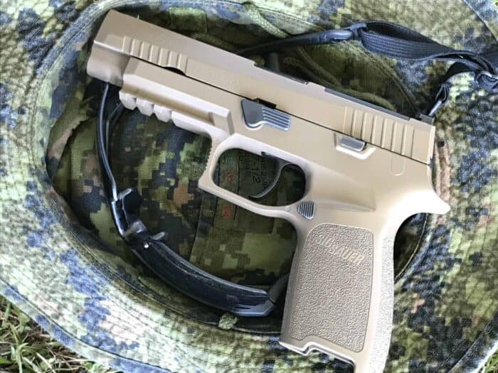 SIG SAUR P320-(C22) sitting on a pair of Revision Sawfly ballistics
