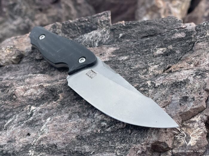 ultimate steel guide - Nija tactical knife on a rock out at the range
